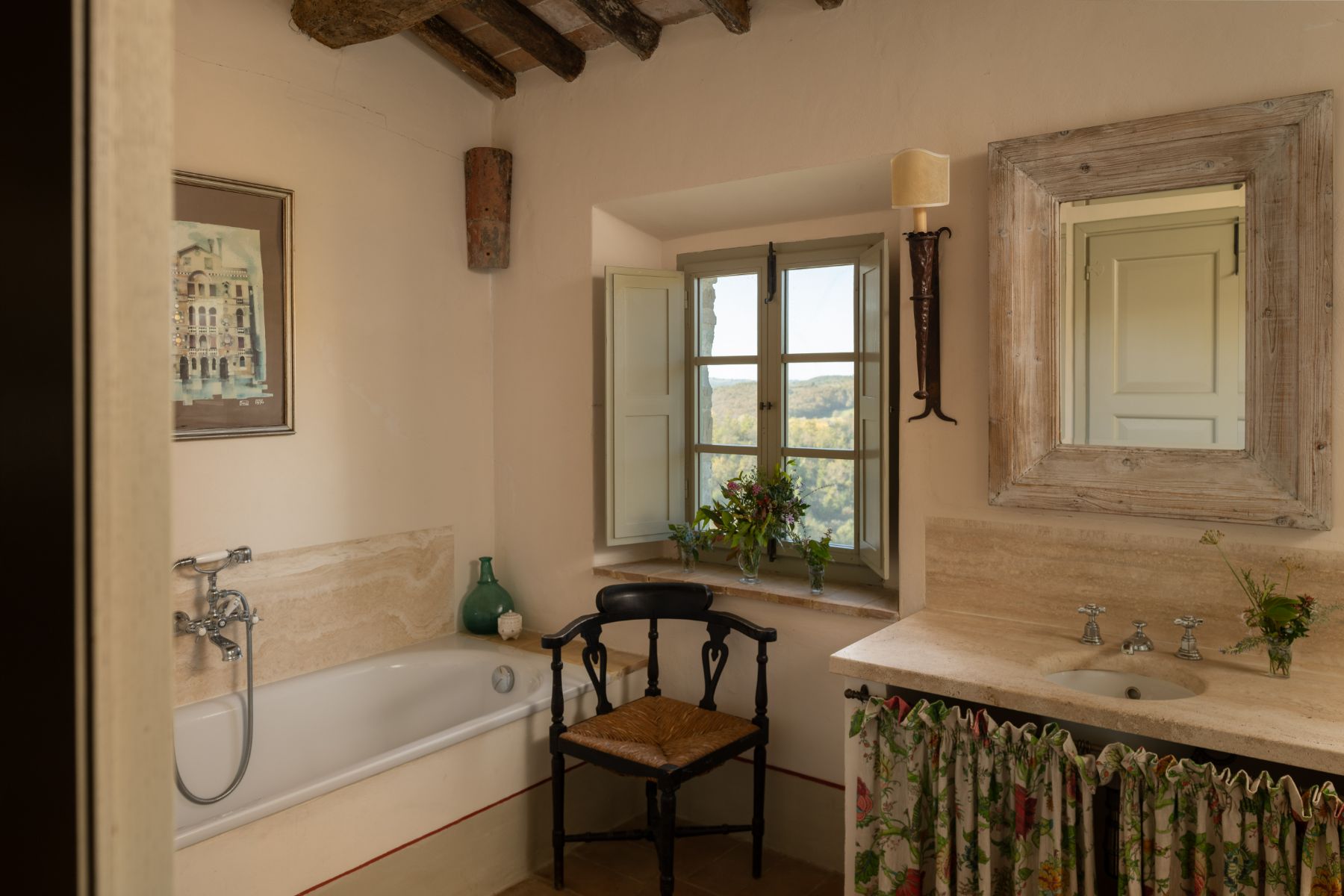 Bathroom with a bath tub and wash basin at Podere Cipressi in Tuscany