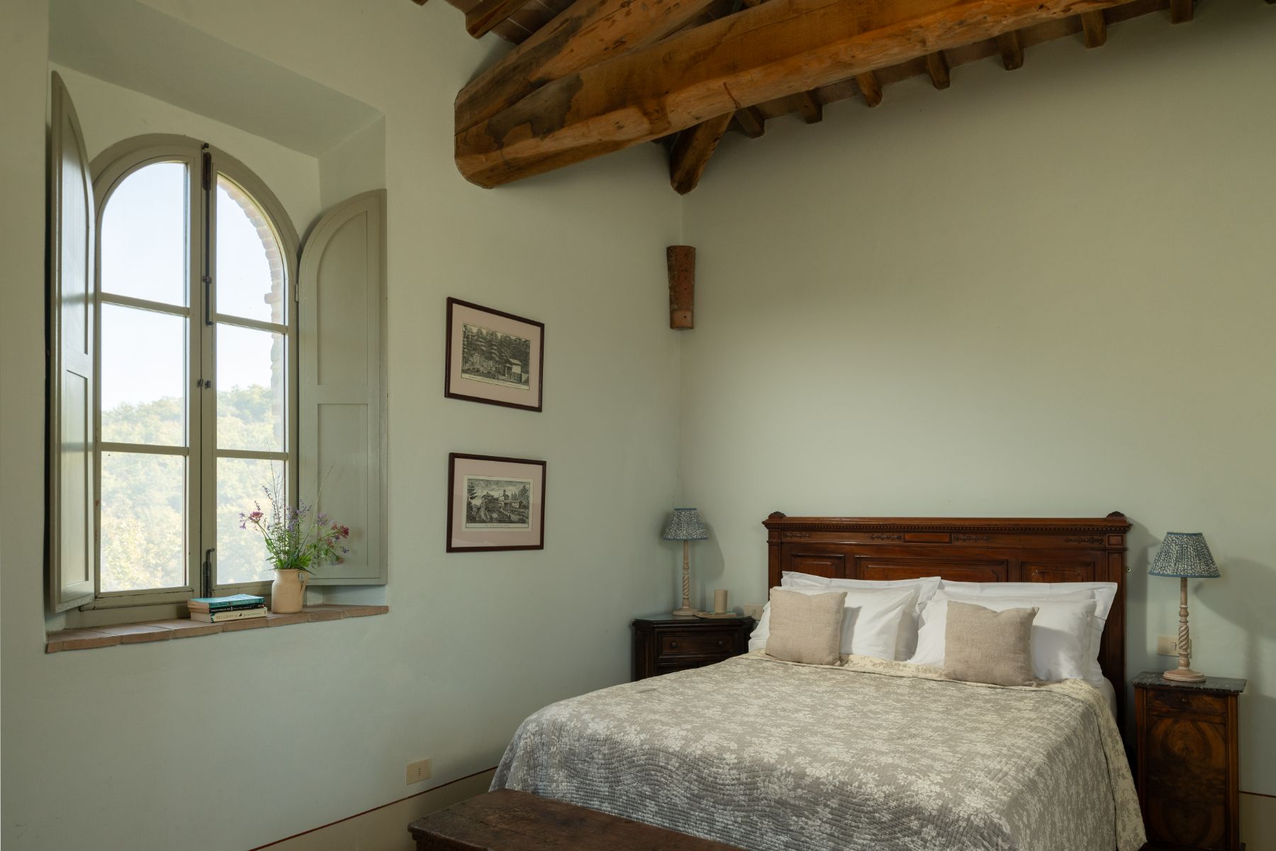 Bedroom with double bed and a large window at Podere Cipressi in Tuscany
