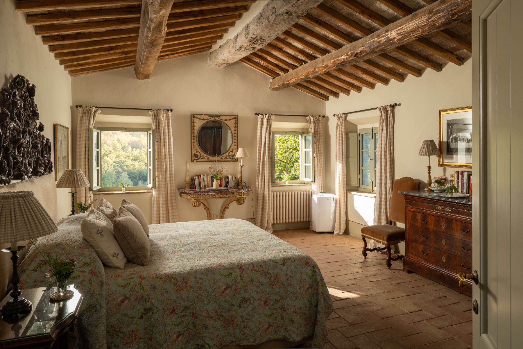 Large bedroom with double bed and wooden beams at Podere Cipressi in Tuscany