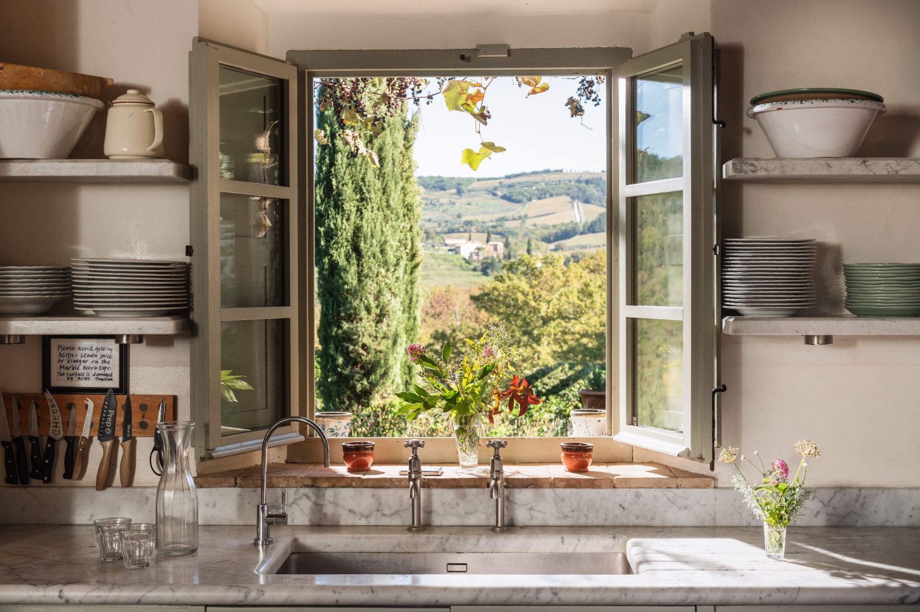 Window from the kitchen with view of the garden at Podere Cipressi in Tuscany