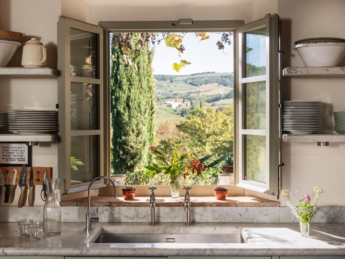Window from the kitchen with view of the garden at Podere Cipressi in Tuscany