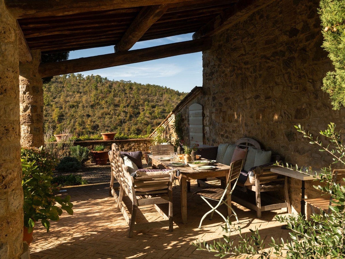 Outdoor dining table overlooking the Tuscan hills at Podere Cipressi