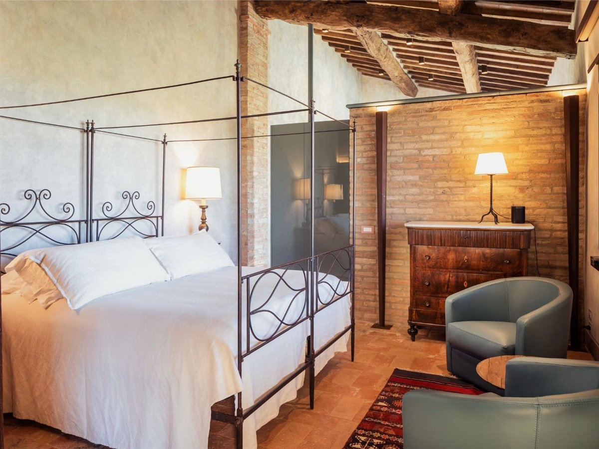 Double bedroom with blue chairs at Podere Martino in Tuscany