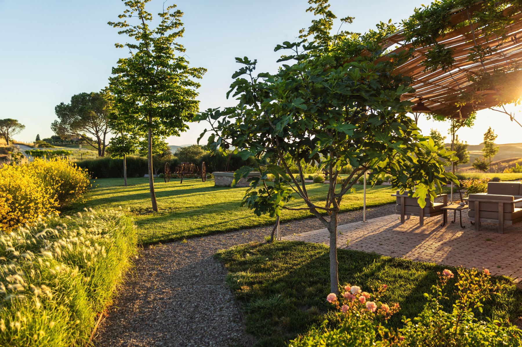 Outdoor area with shaded seating at sunset at luxury villa Podere Martino in Tuscany