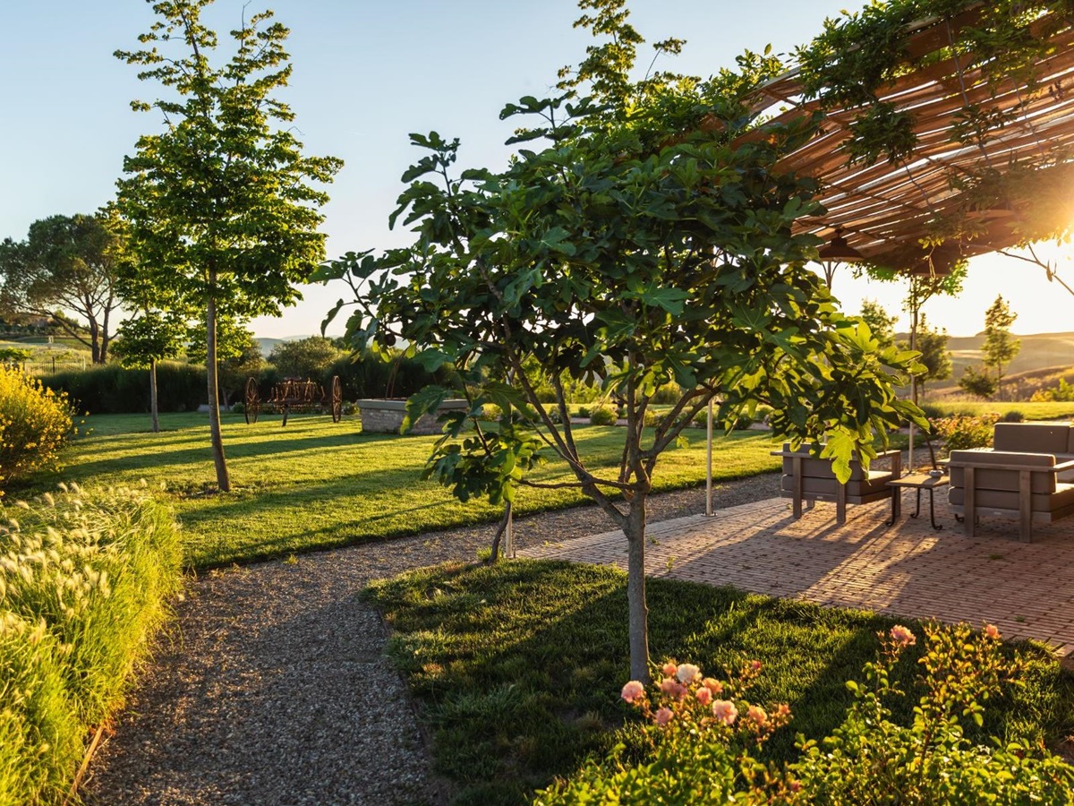 Outdoor area with shaded seating at sunset at luxury villa Podere Martino in Tuscany
