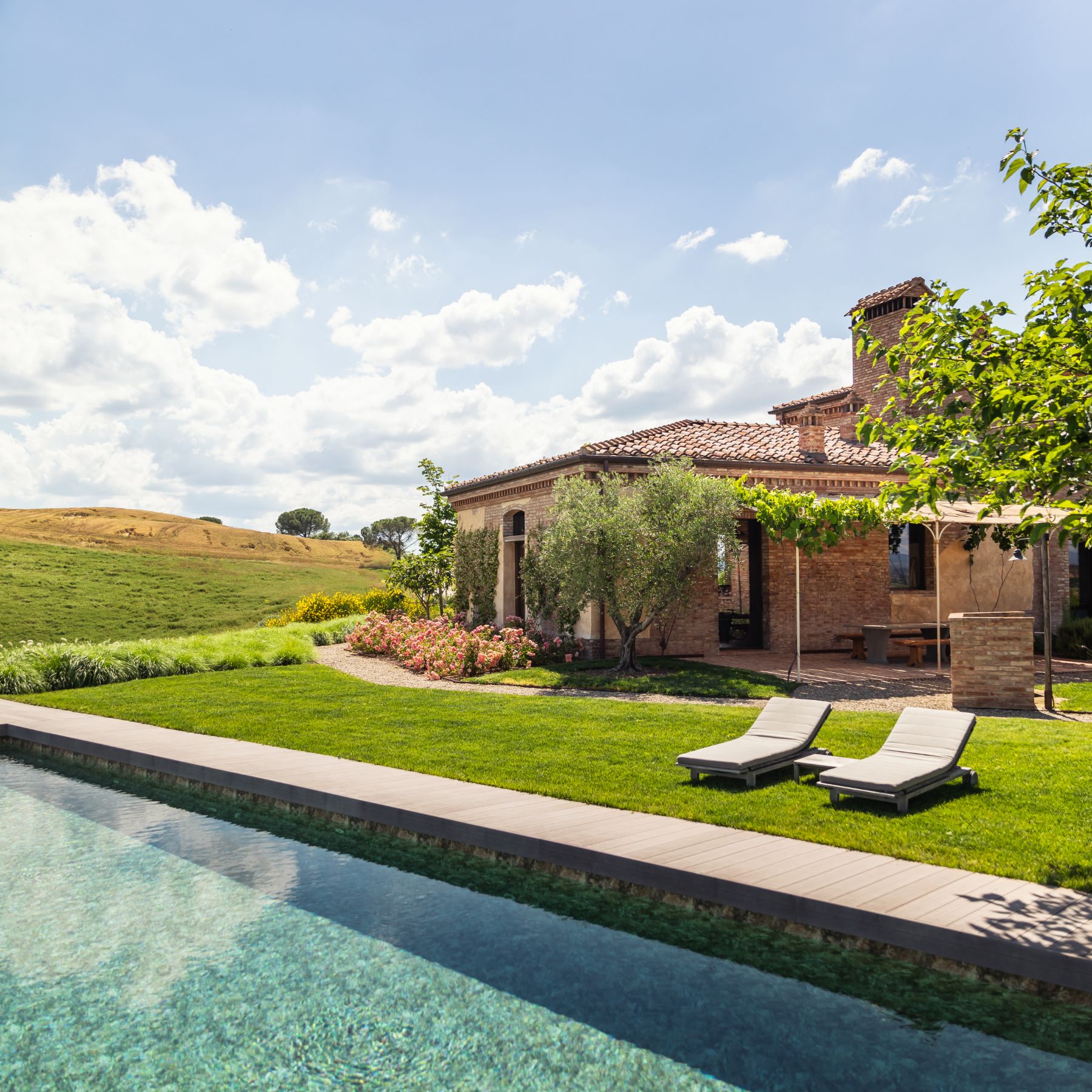 Swimming pool and loungers at Podere Martino, a luxury villa in Tuscany