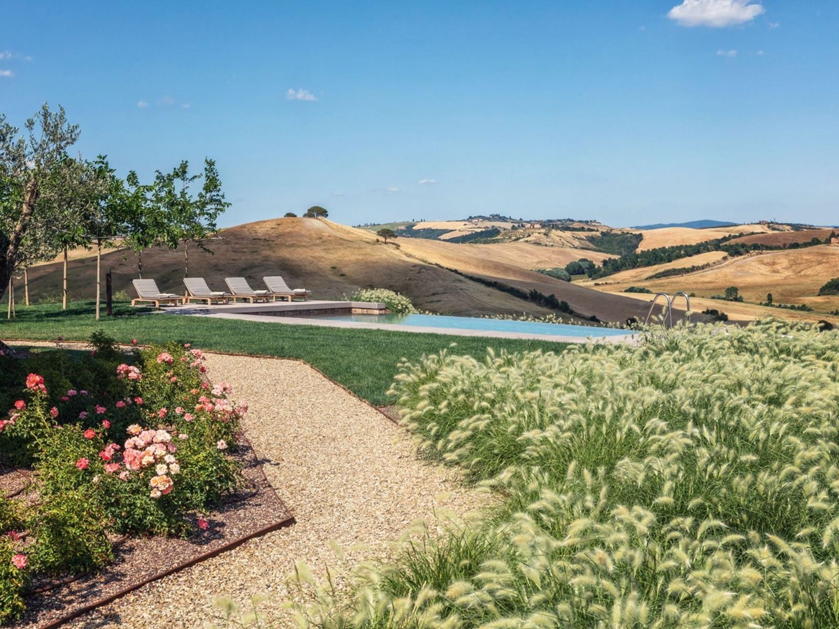 Path leading to swimming pool with views over Tuscan hills at private villa Podere Martino in Tuscany