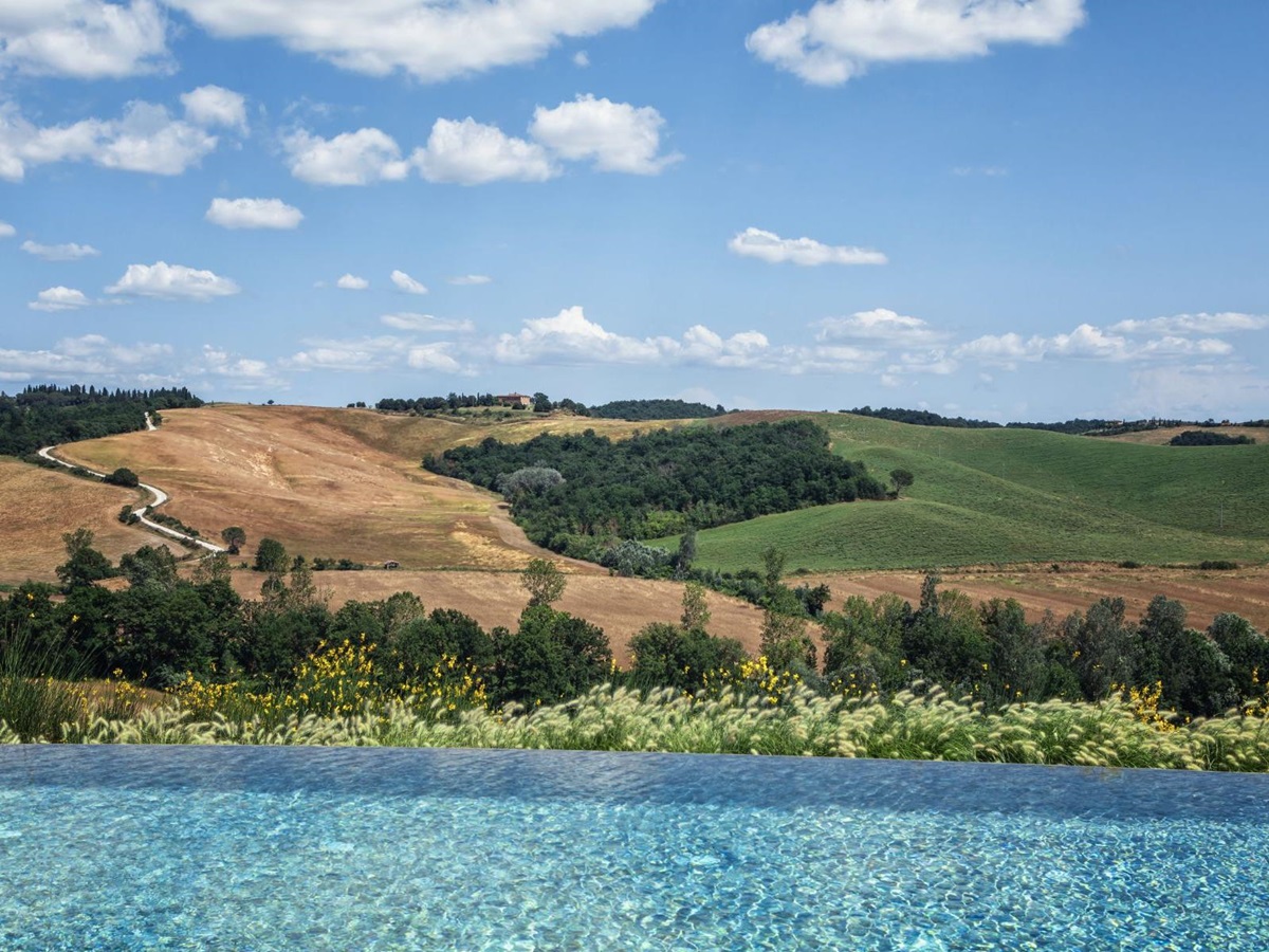 View from pool looking out over beautiful Tuscan scenery at luxury villa Podere Martino in Tuscany