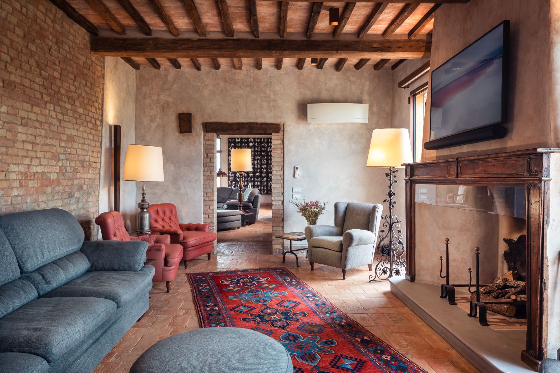 TV room with sofas and large screen at Podere Martino, a luxury villa in Tuscany
