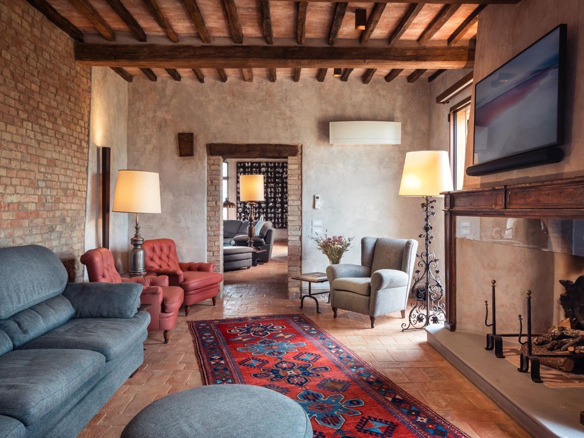 TV room with sofas and large screen at Podere Martino, a luxury villa in Tuscany