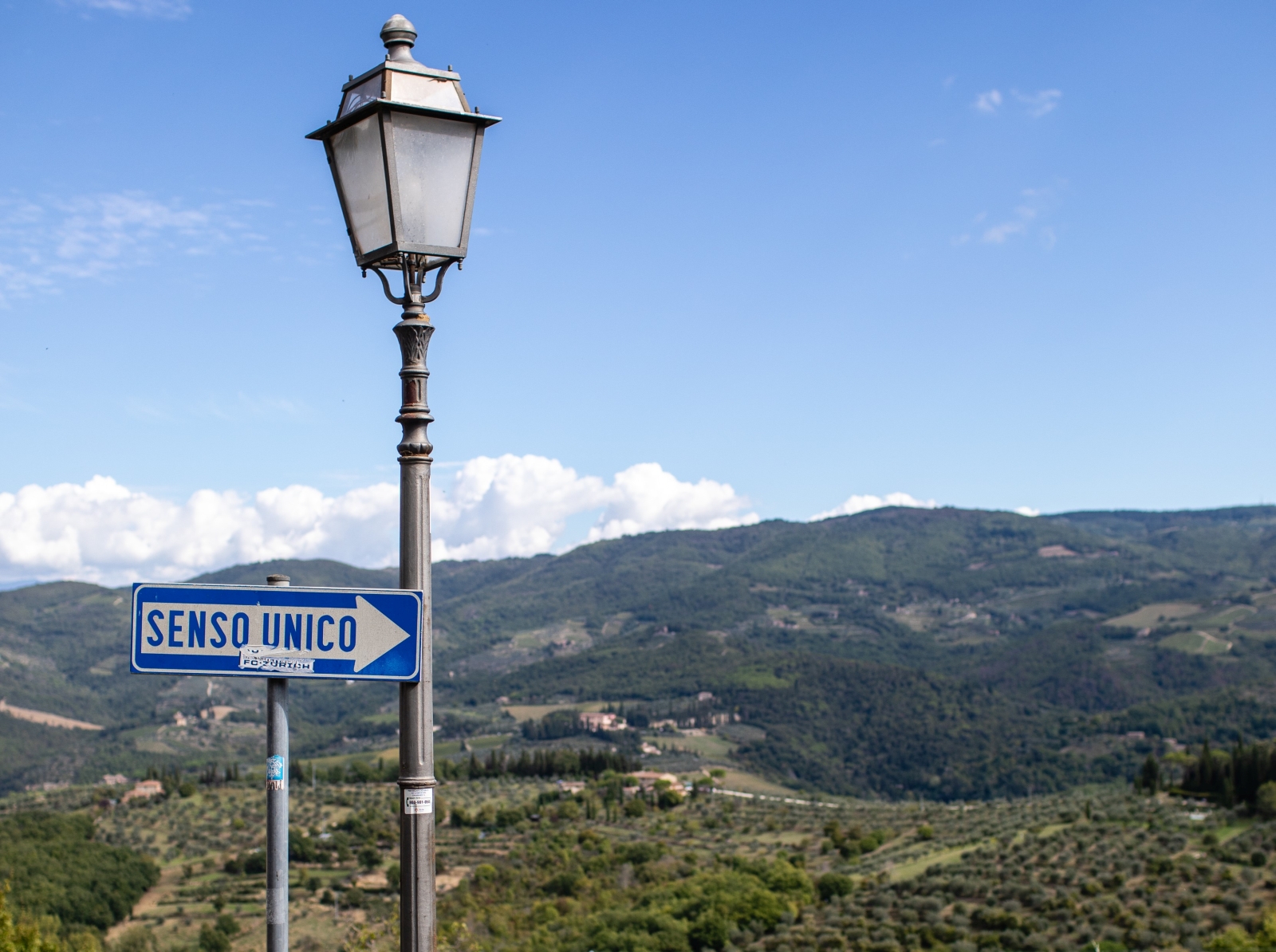 Road sign and lamp post in Tuscan countryside near to Tenuta Cantata in Tuscany, Italy