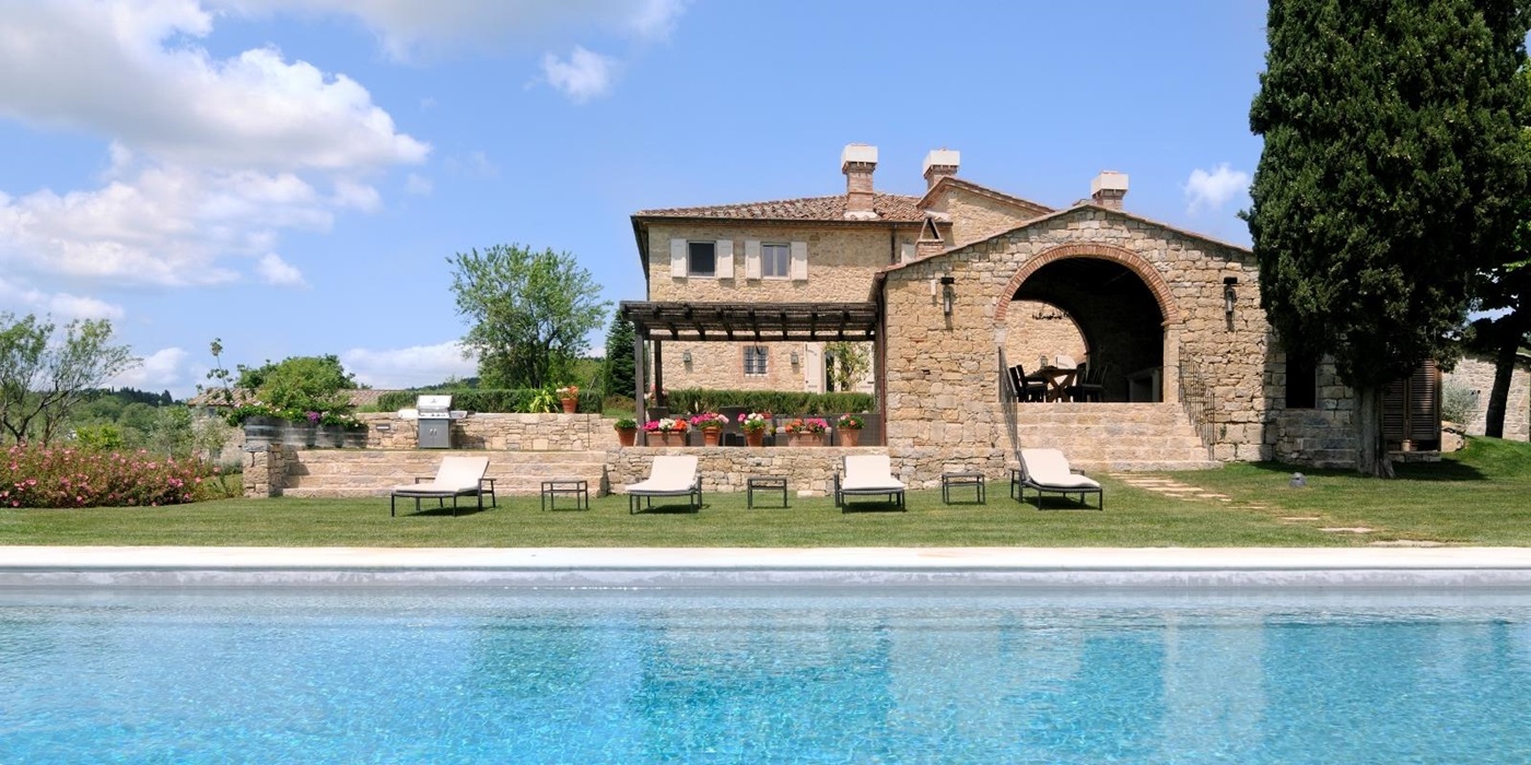 The swimming pool, sun loungers and facade of Tramonti, Tuscany