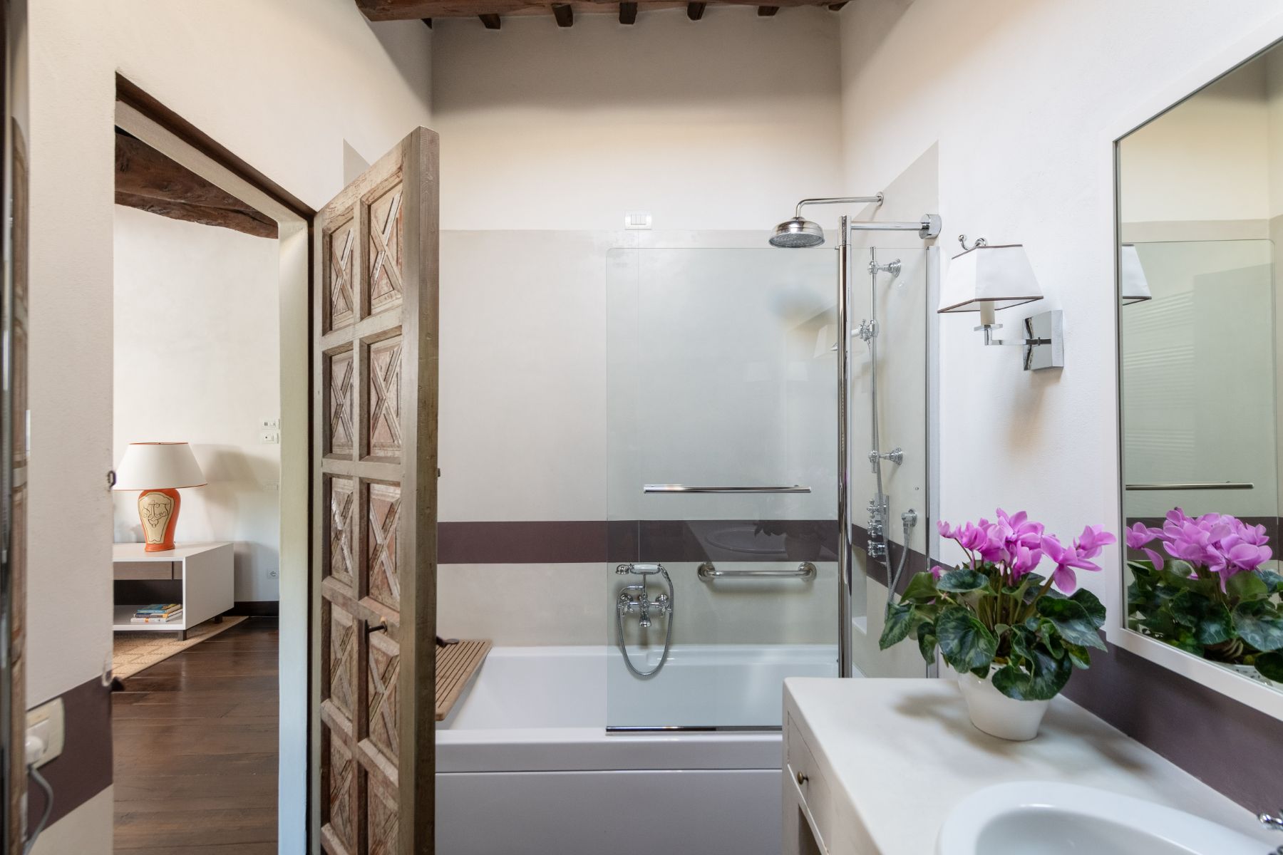 Ensuite bathroom with a bath tub and shower head at Tramonti in Tuscany