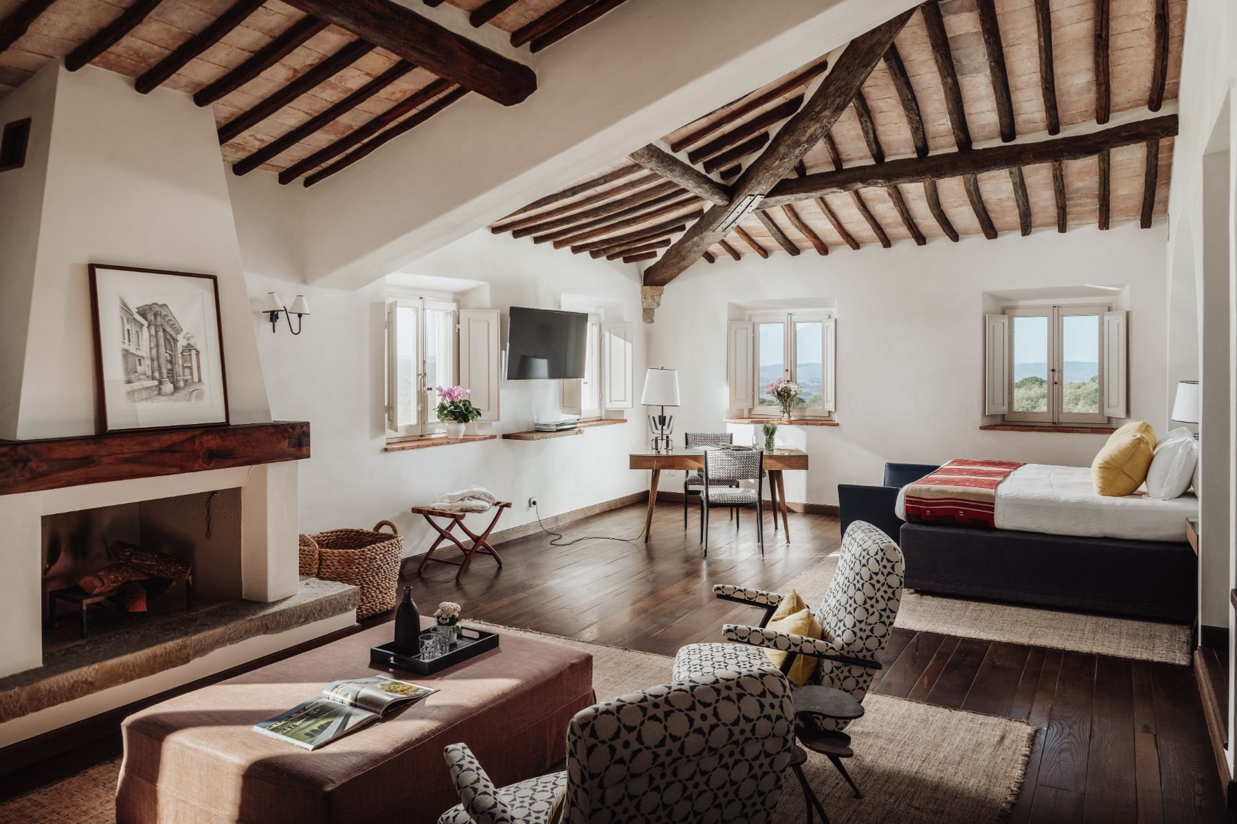 Bedroom with large double bed and armchairs in Tramonti in Tuscany