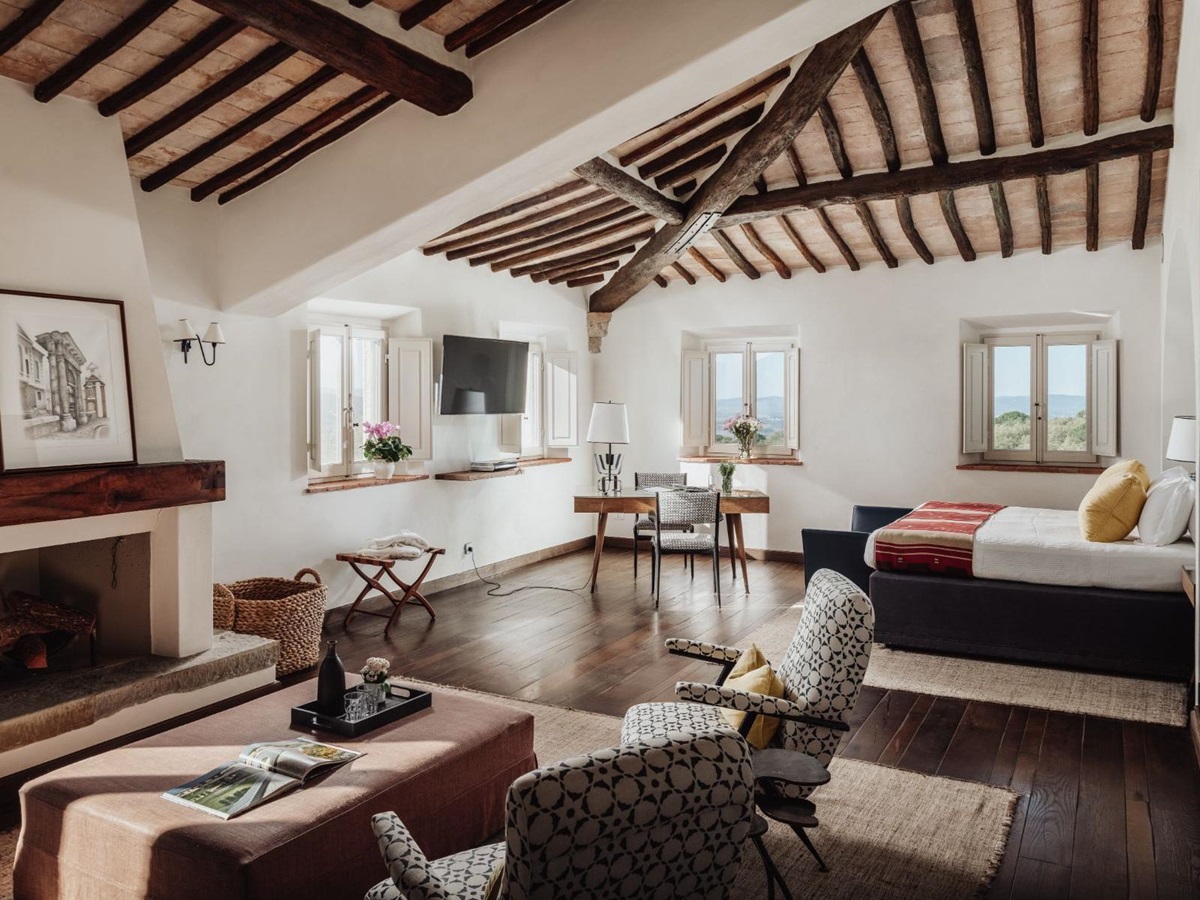 Bedroom with large double bed and armchairs in Tramonti in Tuscany