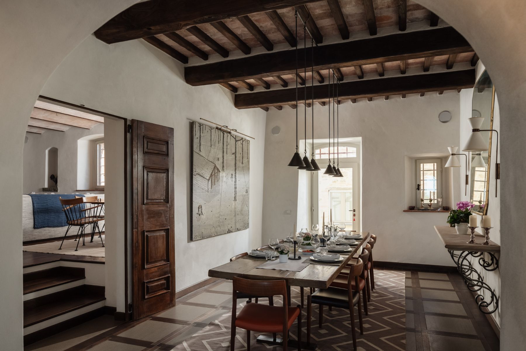 Indoor dining room with long wooden table at Tramonti in Tuscany
