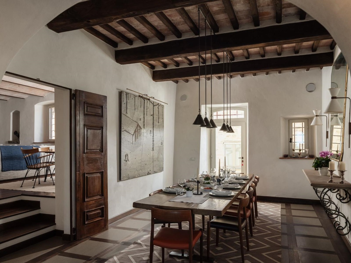 Indoor dining room with long wooden table at Tramonti in Tuscany