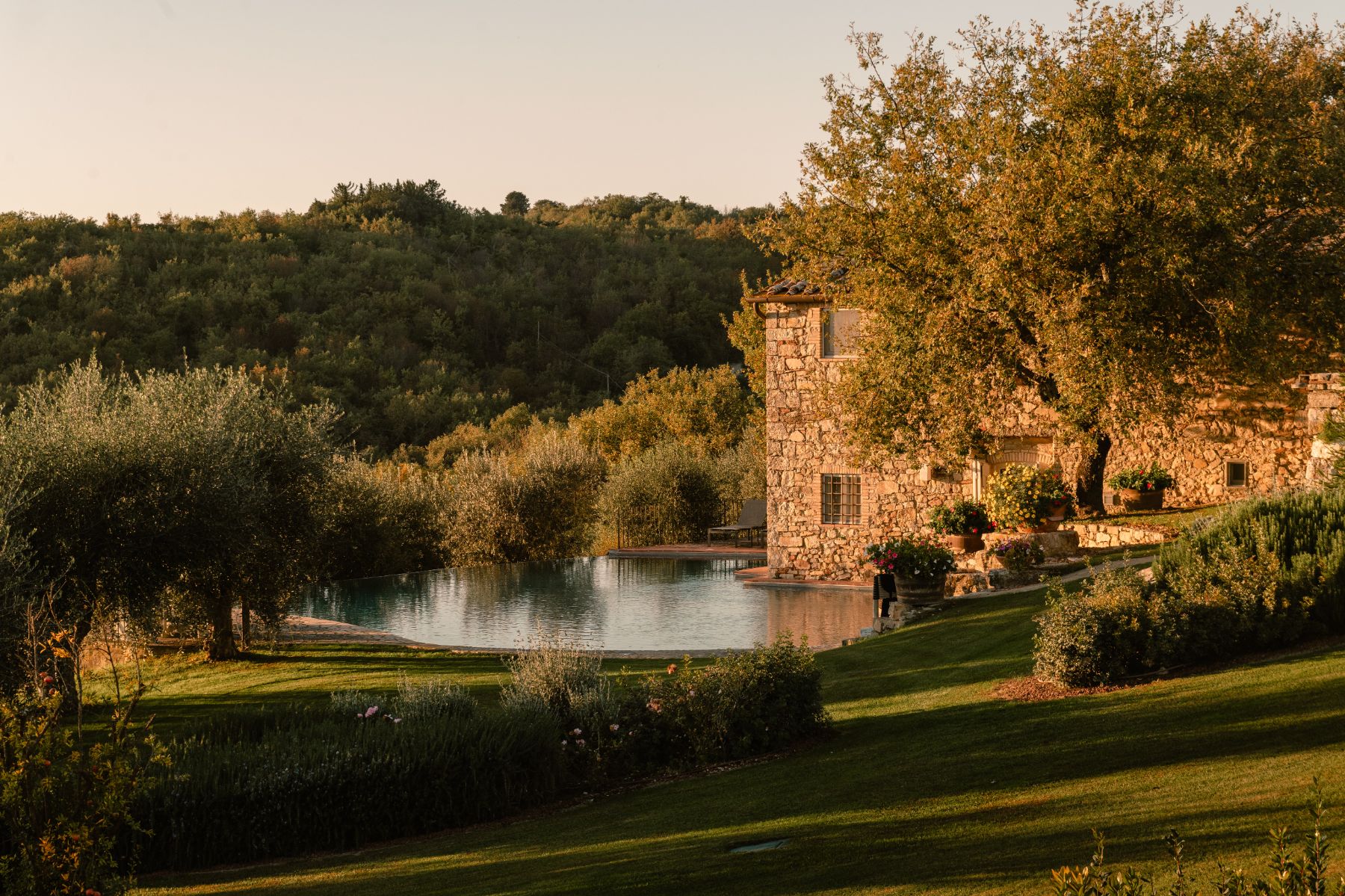 Second pool area with view of the gardens and villa at Tramonti in Tuscany