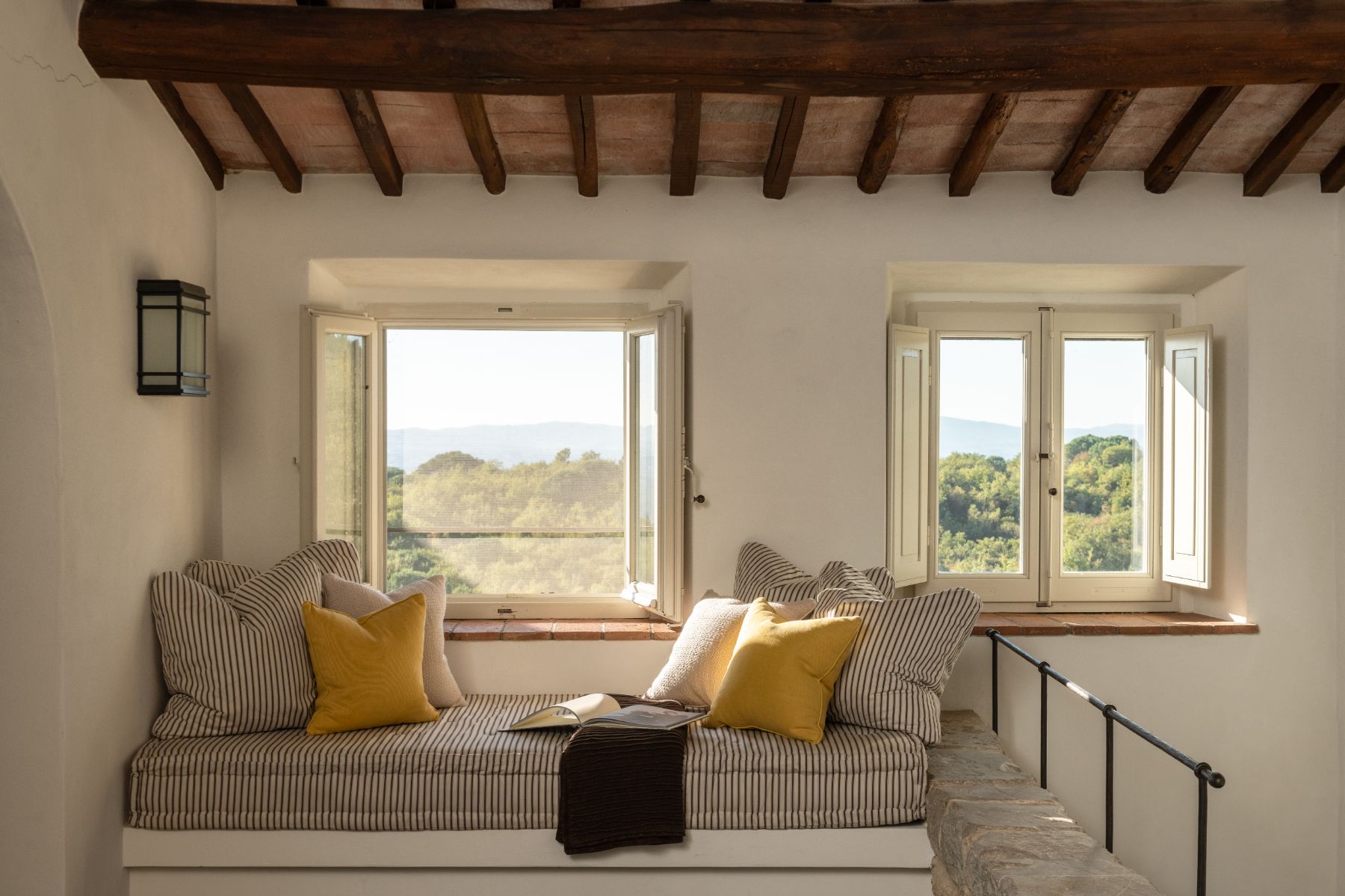 Window seat with cushions overlooking the Tuscan hills at Tramonti