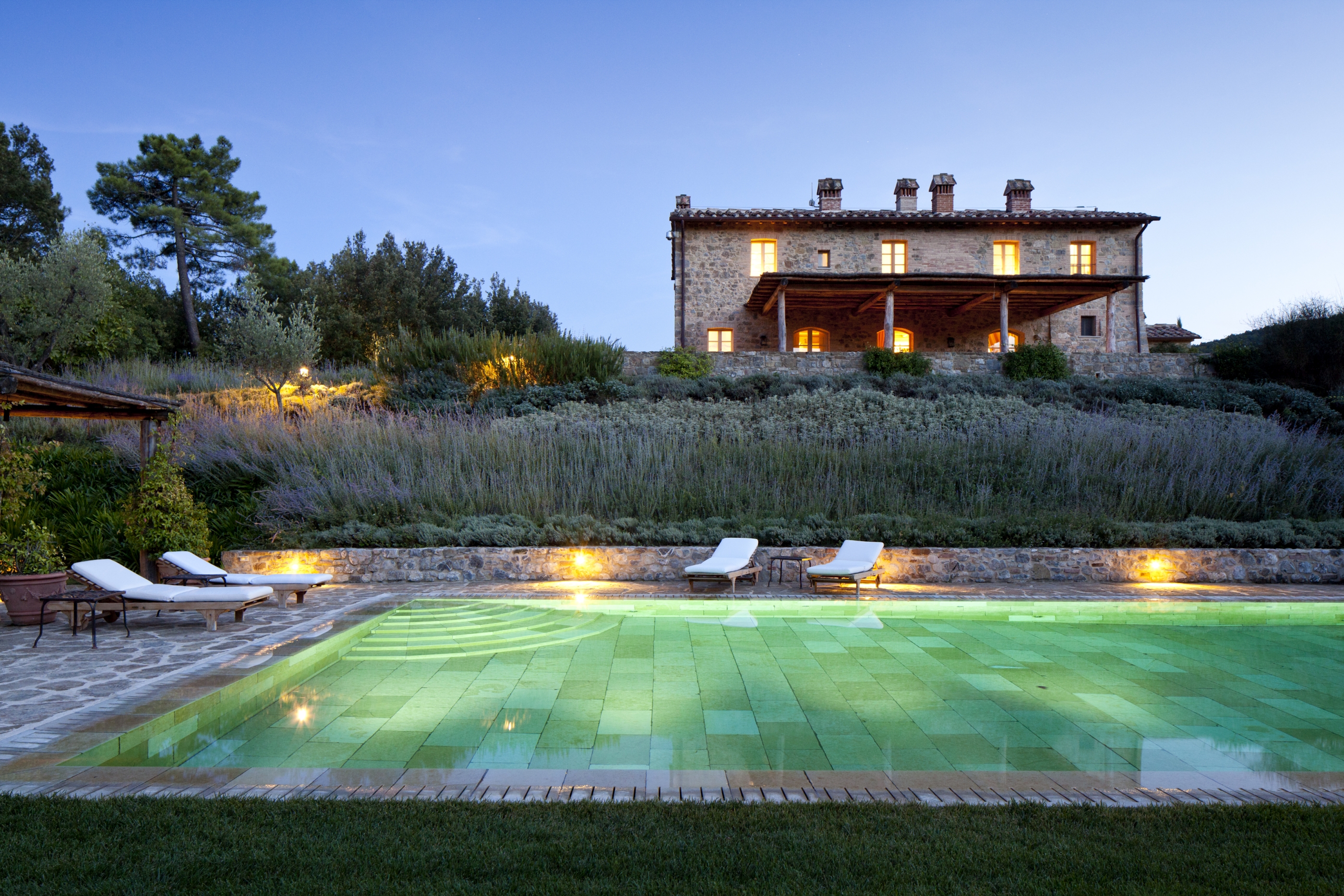 Lit pool and facade of Villa Alba,  Tuscany