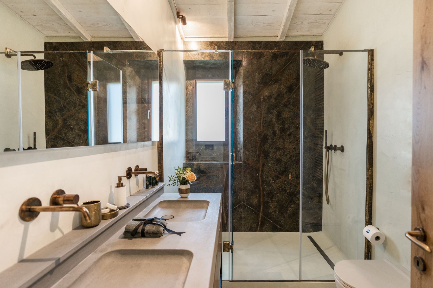 Modern bathroom with a marble shower at Villa Ardore in Tuscany