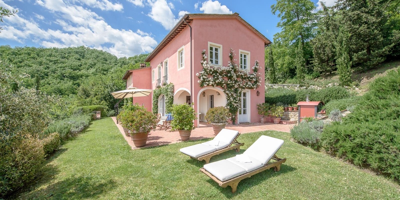 Two sun loungers and facade of Villa Barboleta, Tuscany