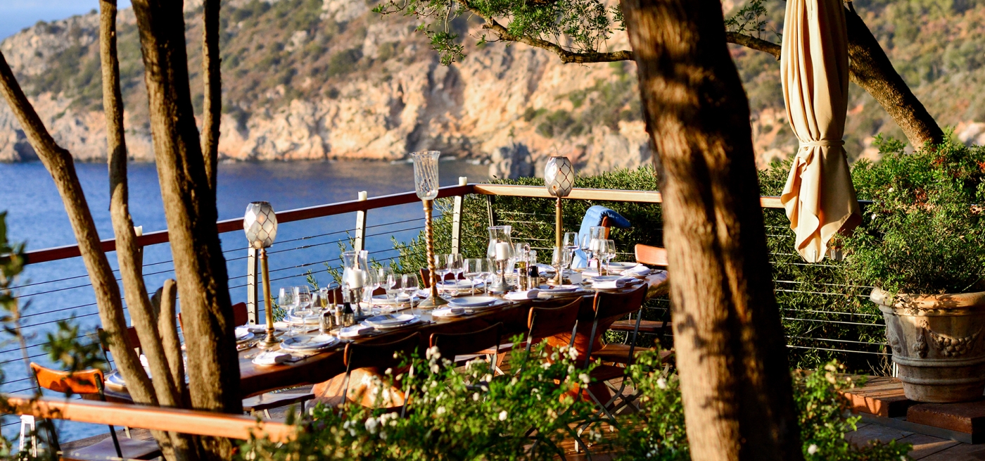 Dining outside with view of sea at Villa Bianca in Tuscany