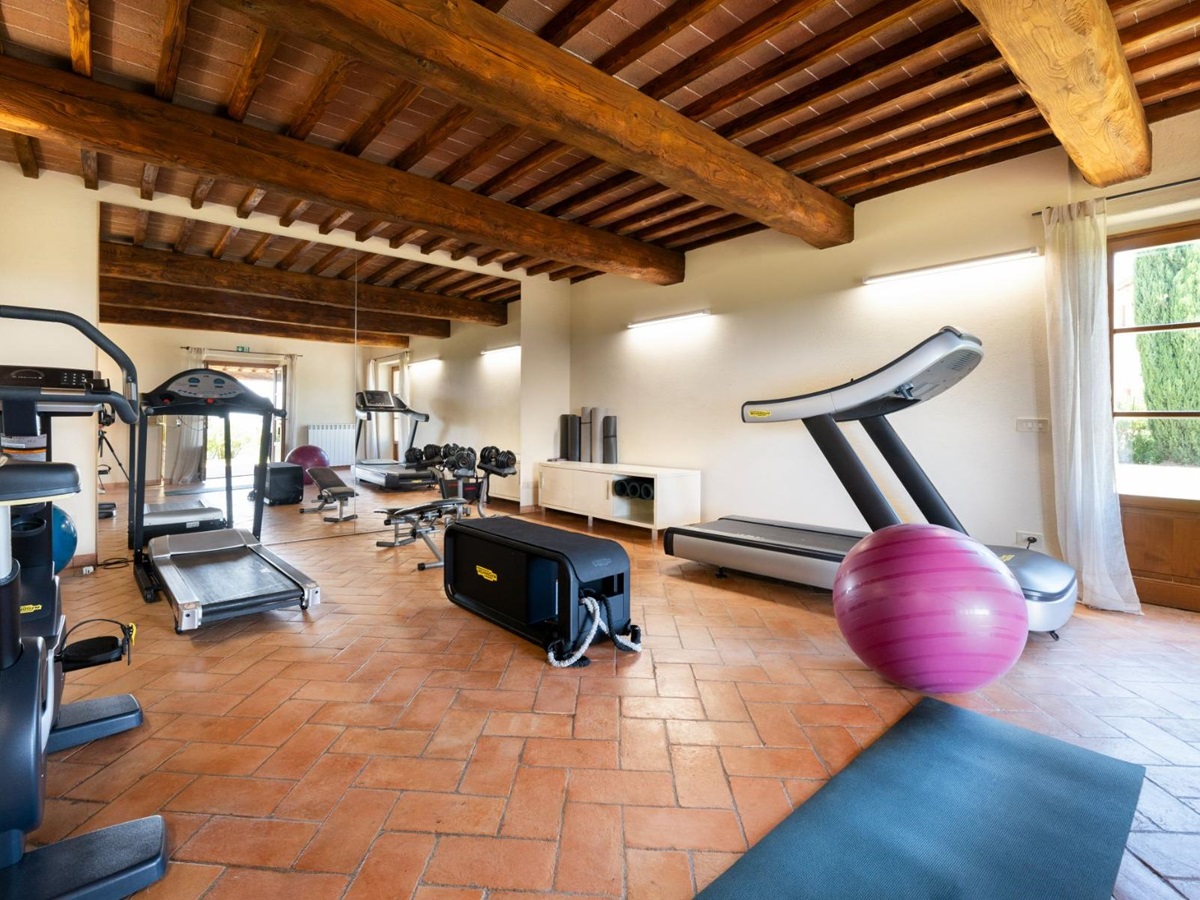 Gym room with running machine, mats and yoga ball in Villa Cispiano in Tuscany