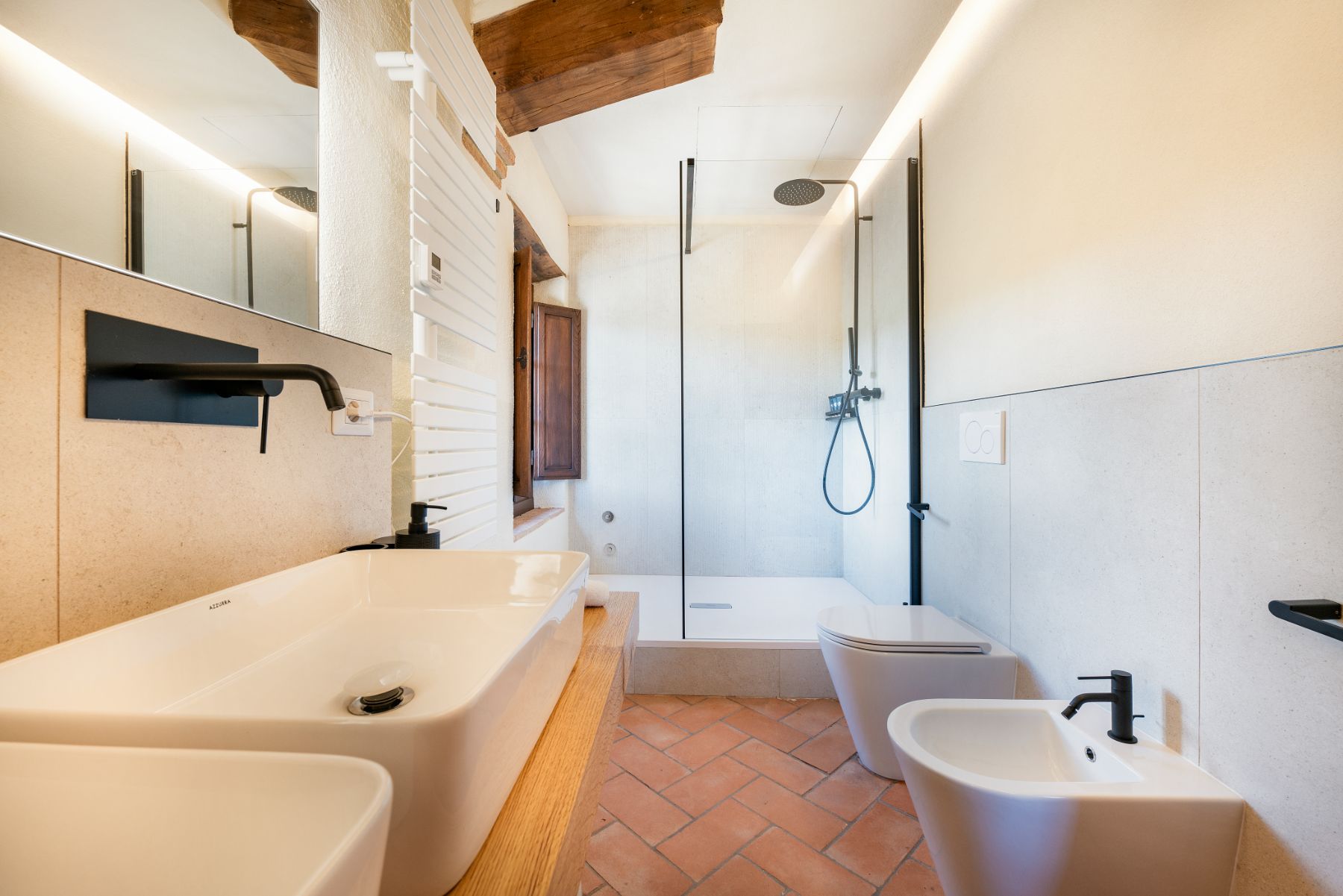 Bathroom with large bath and shower in Villa Cispiano in Tuscany