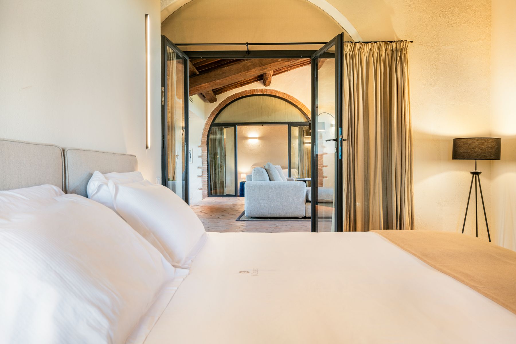 Bedroom with view into living room at Villa Cispiano in Tuscany