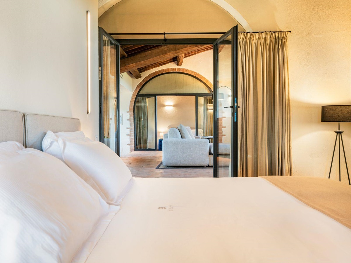 Bedroom with view into living room at Villa Cispiano in Tuscany