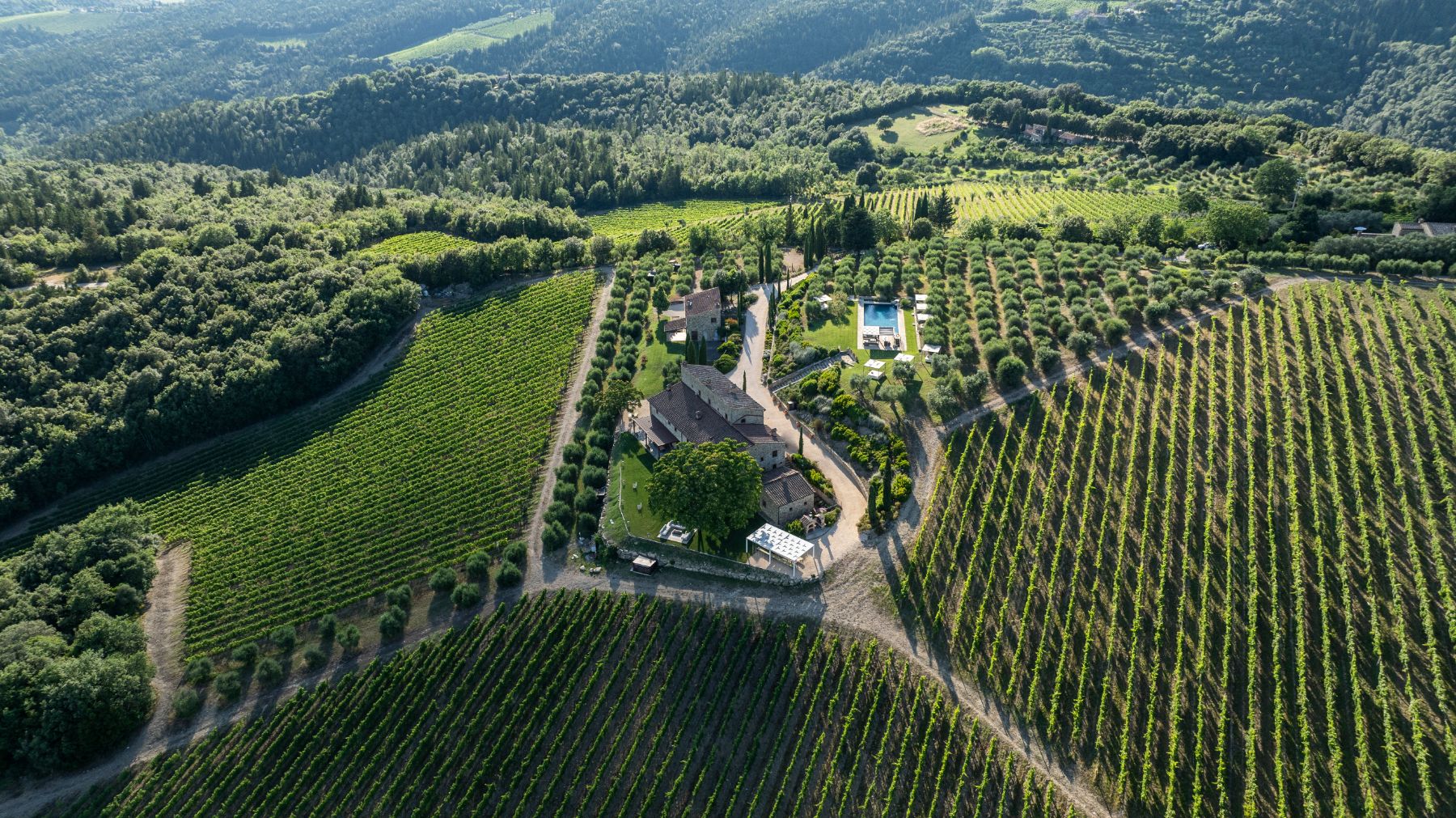 Drone view of Villa Cispiano in Tuscany, surrounded by vineyards