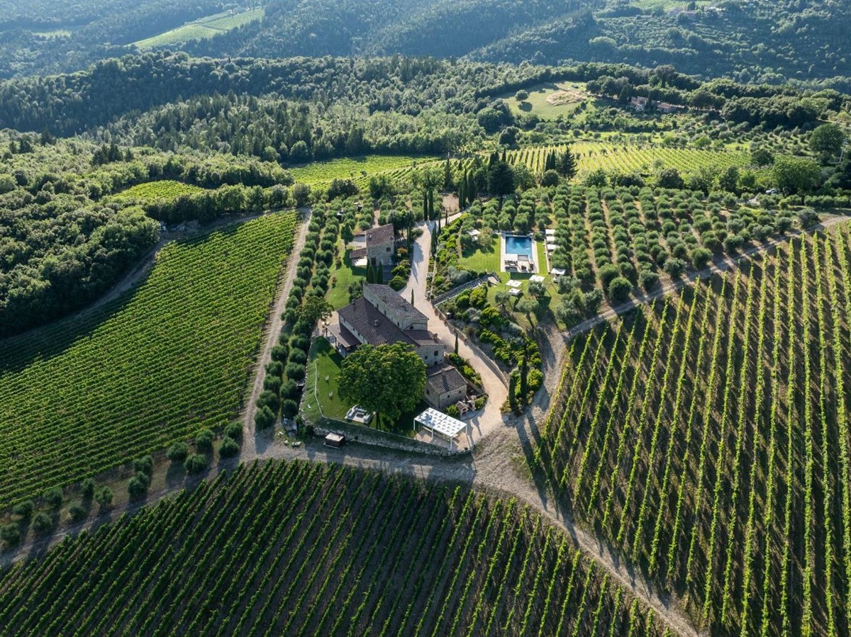 Drone view of Villa Cispiano in Tuscany, surrounded by vineyards