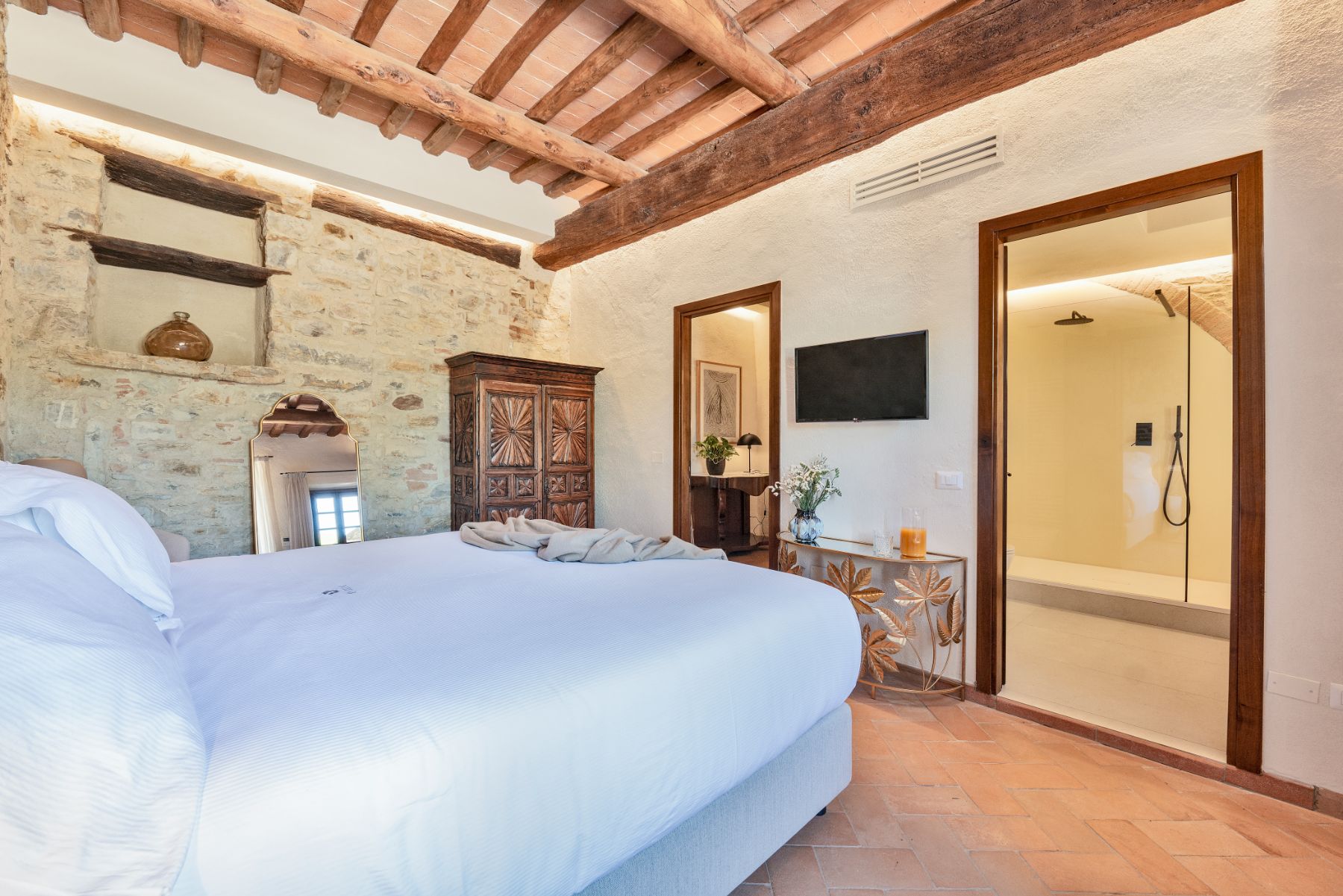 Bedroom with view of modern ensuite bathroom at Villa Cispiano in Tuscany