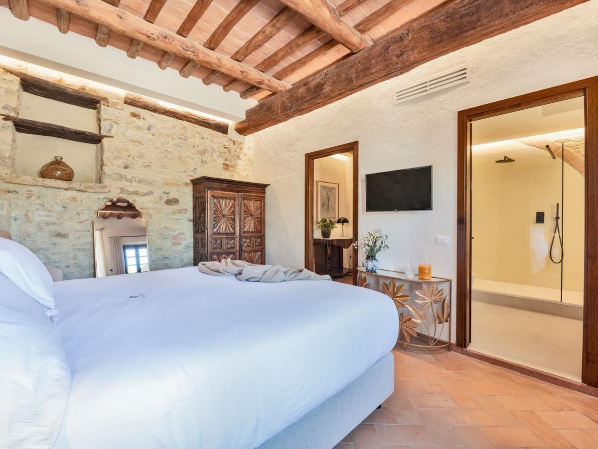 Bedroom with view of modern ensuite bathroom at Villa Cispiano in Tuscany