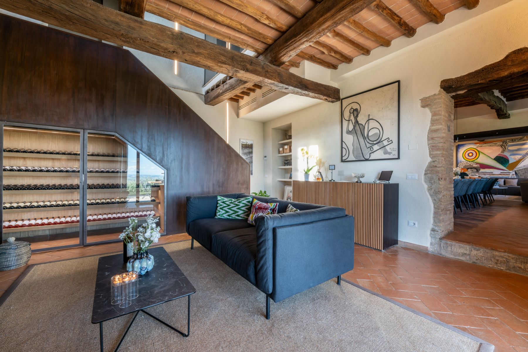 Indoor seating area and view of wine storage unit at Villa Cispiano in Tuscany