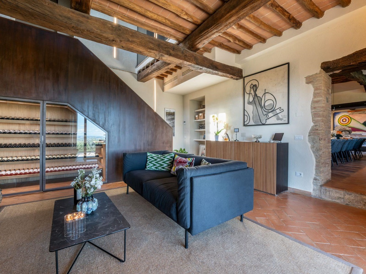 Indoor seating area and view of wine storage unit at Villa Cispiano in Tuscany