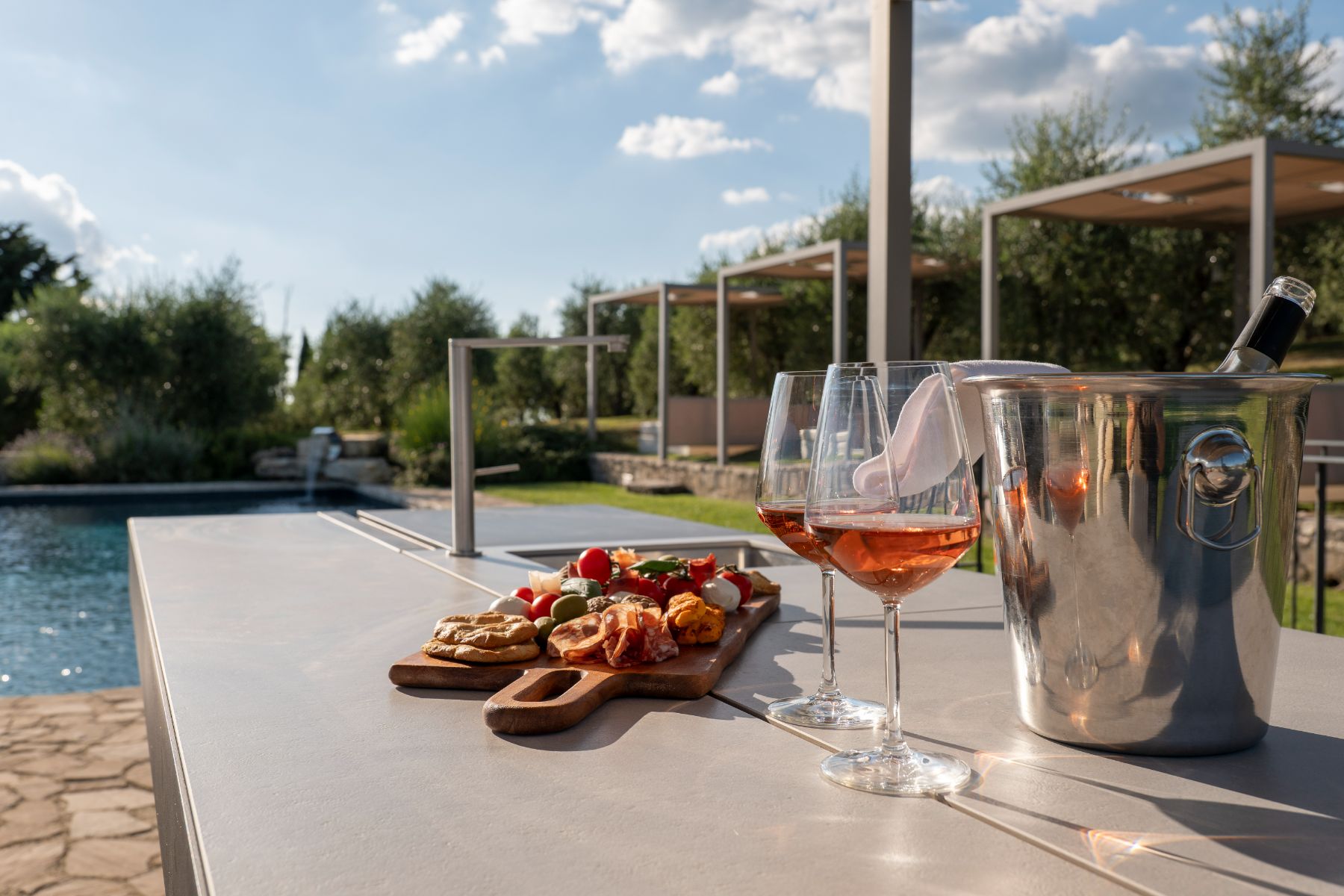 Outdoor table with Il Cellese wine by the pool at Villa Cispiano in Tuscany