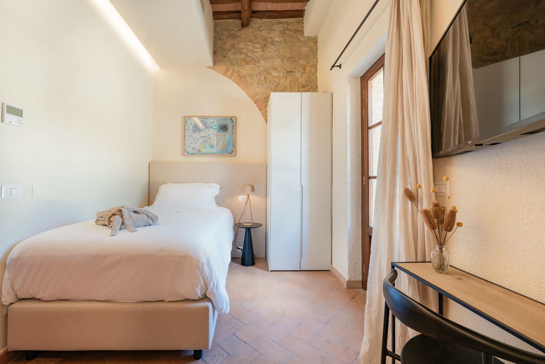 Single bedroom with modern decor in Villa Cispiano in Tuscany 