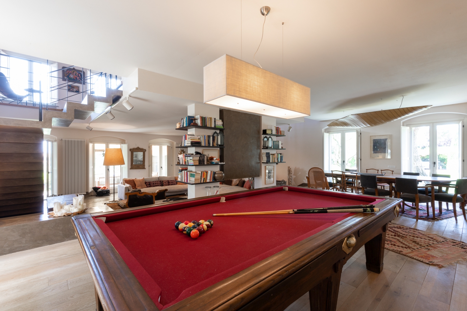 Red billiard table with dining area in backhground at Villa del Gelso, Tuscany
