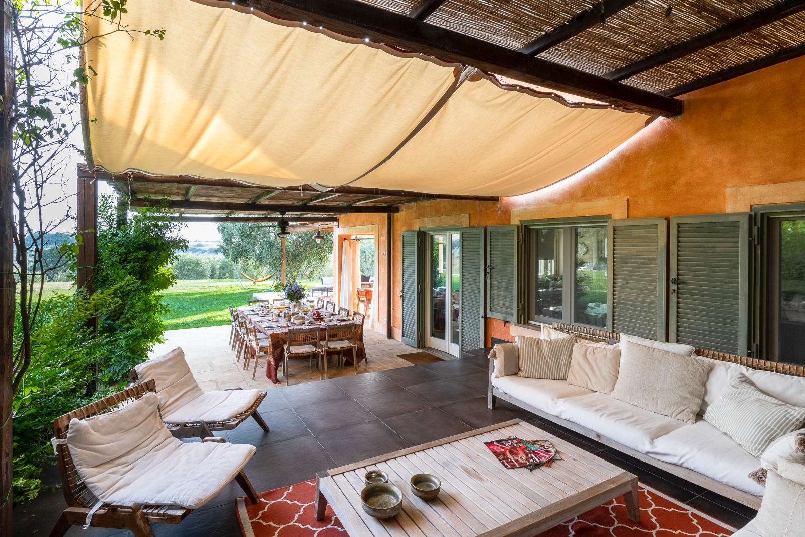Outdoor seating with canvas covering at Villa del Gelso, Tuscany