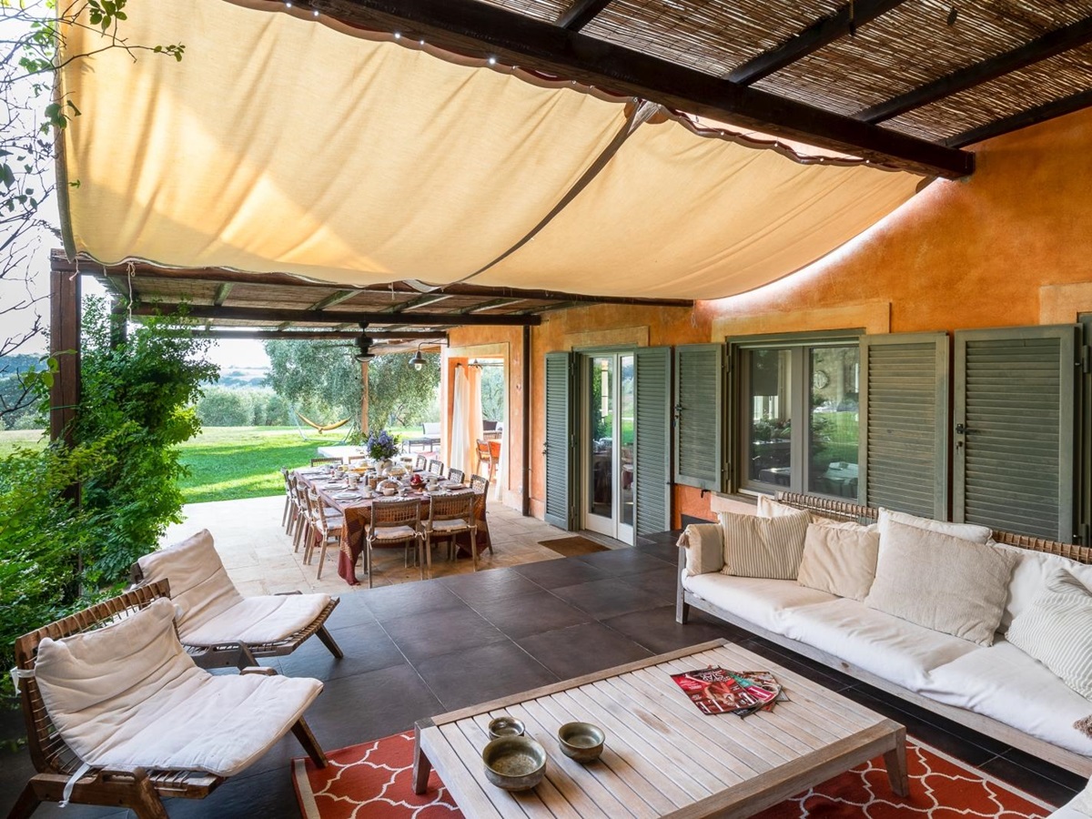 Outdoor seating with canvas covering at Villa del Gelso, Tuscany