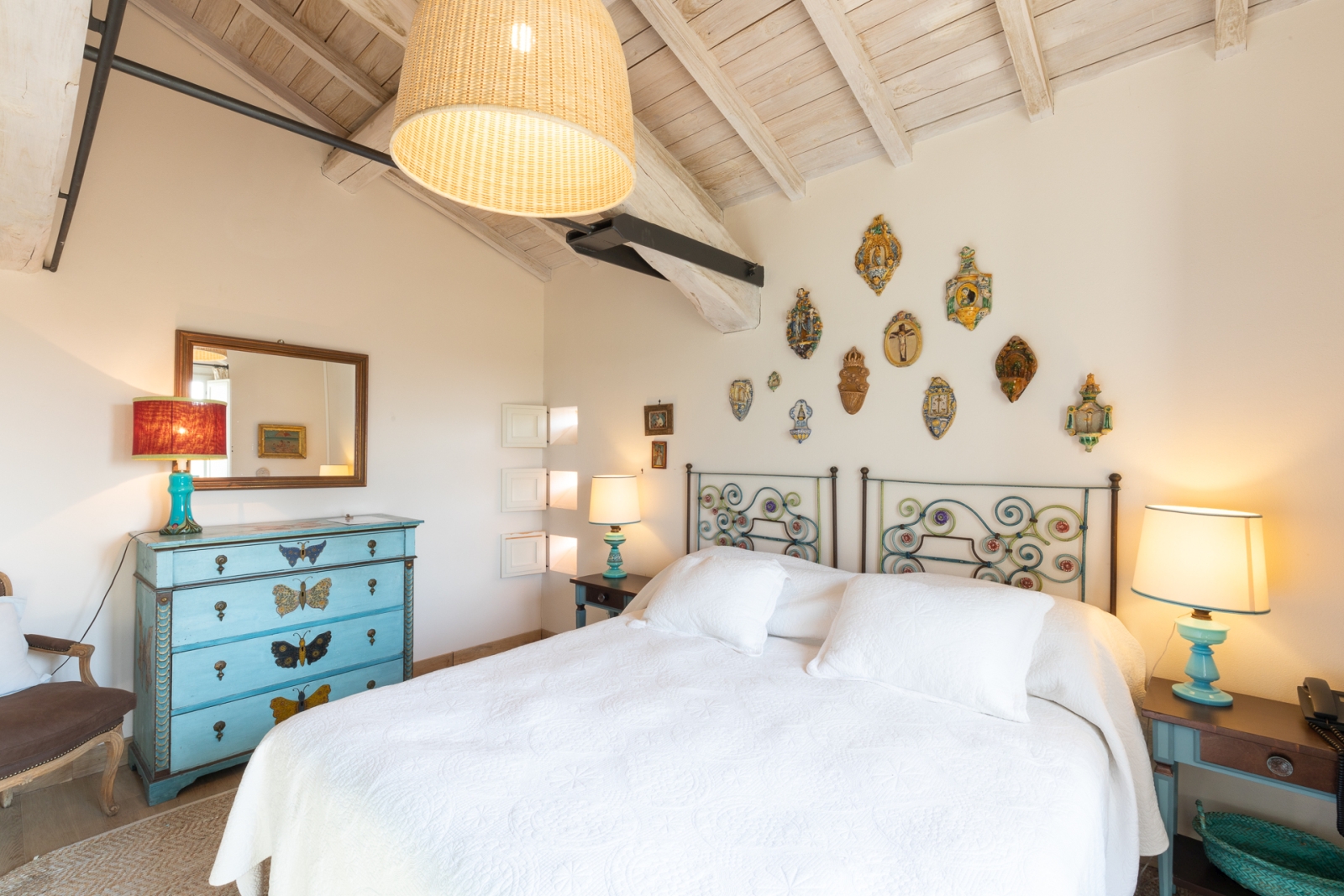 Double bedroom with ornaments on the wall at Villa del Gelso, Tuscany