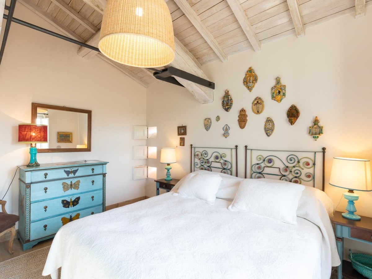 Double bedroom with ornaments on the wall at Villa del Gelso, Tuscany