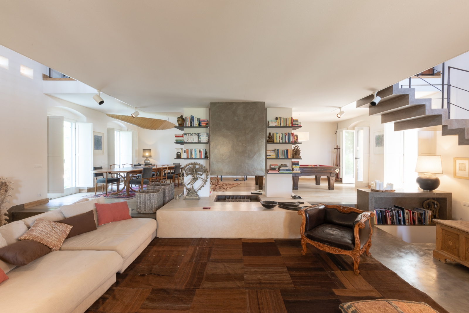 Downstairs living room with wooden floor and cream sofas at Villa del Gelso, Tuscany