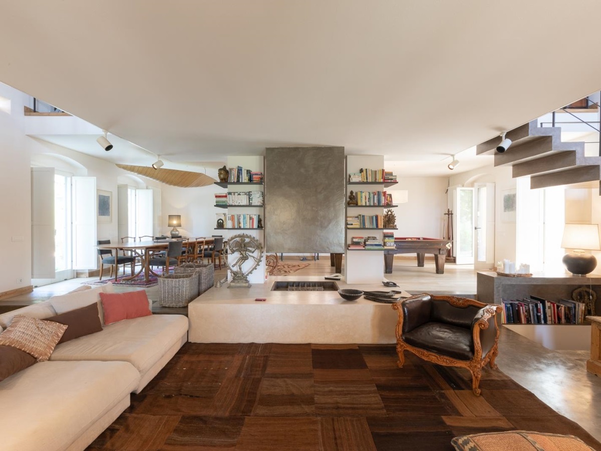 Downstairs living room with wooden floor and cream sofas at Villa del Gelso, Tuscany