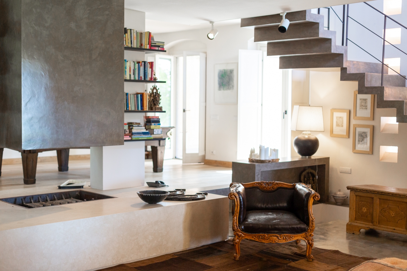 Living room with modern central fireplace at Villa del Gelso, Tuscany