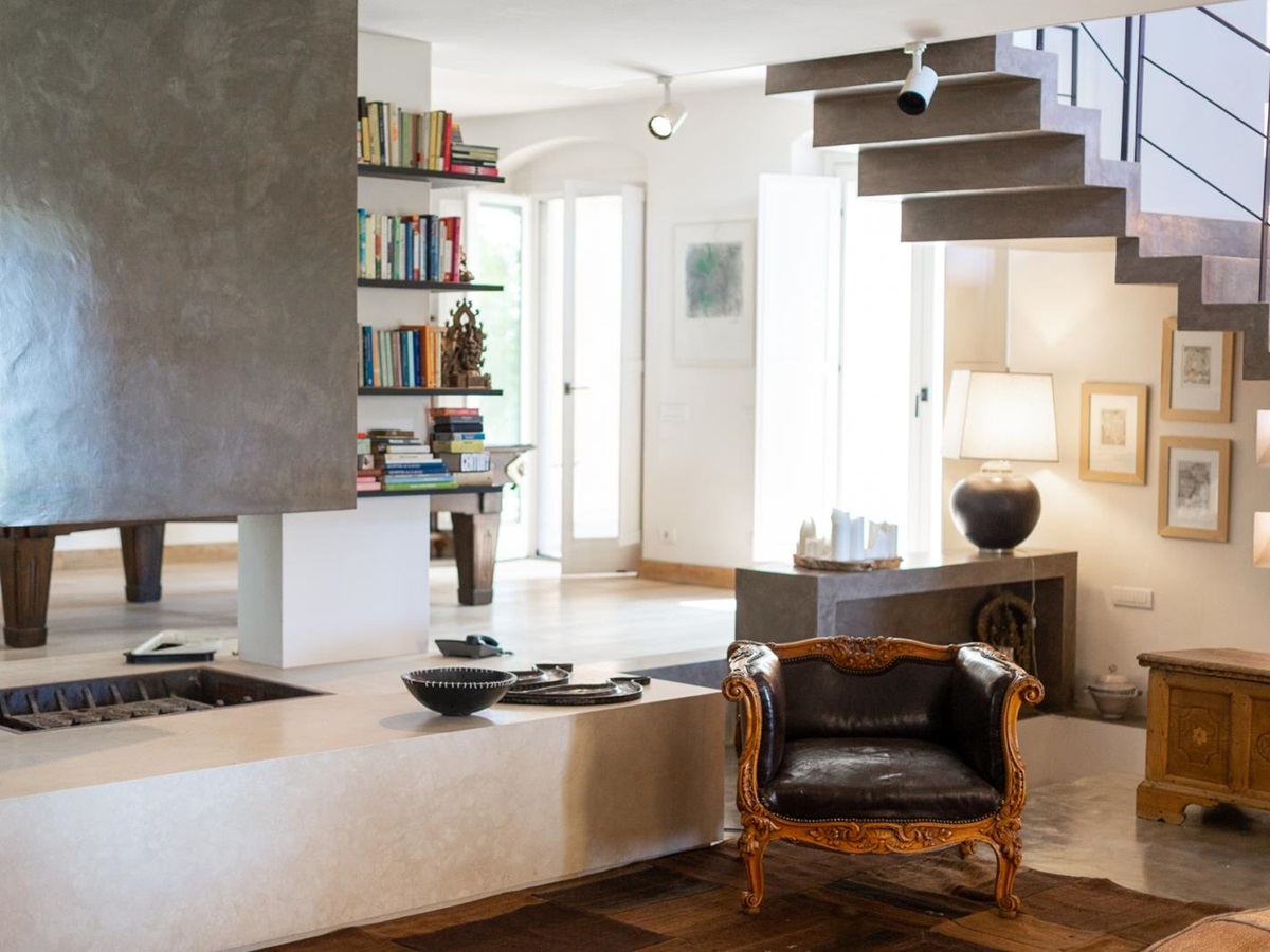 Living room with modern central fireplace at Villa del Gelso, Tuscany