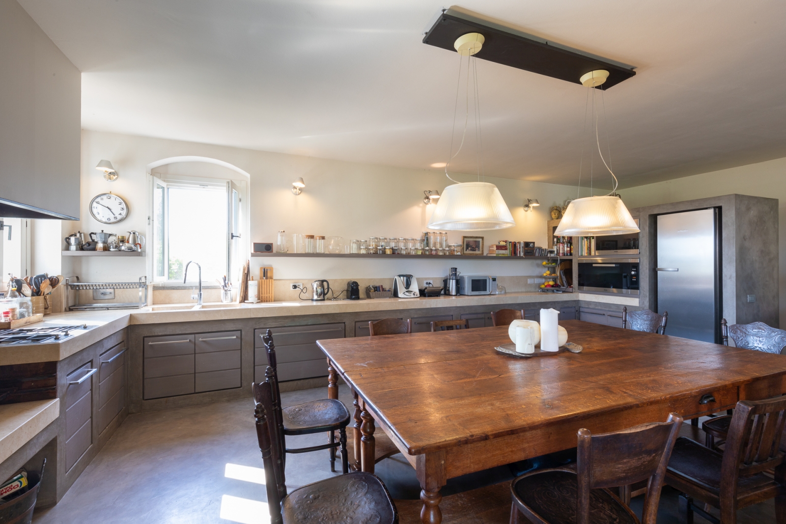 Kitchen with large wooden table at Villa del Gelso, Tuscany