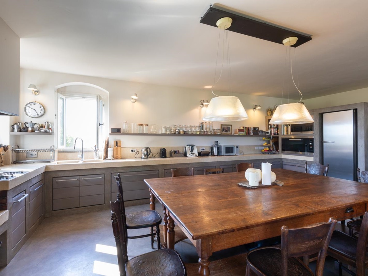 Kitchen with large wooden table at Villa del Gelso, Tuscany